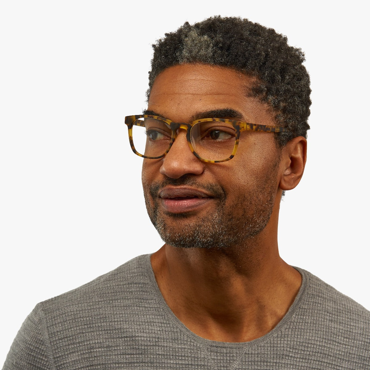 Person wearing tortoise square reading glasses