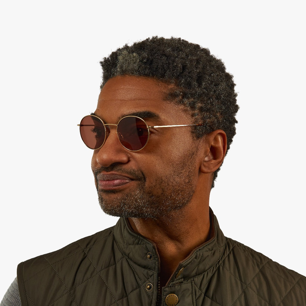 Person wearing Men's Tromsø Gold round sunglasses with gold frames