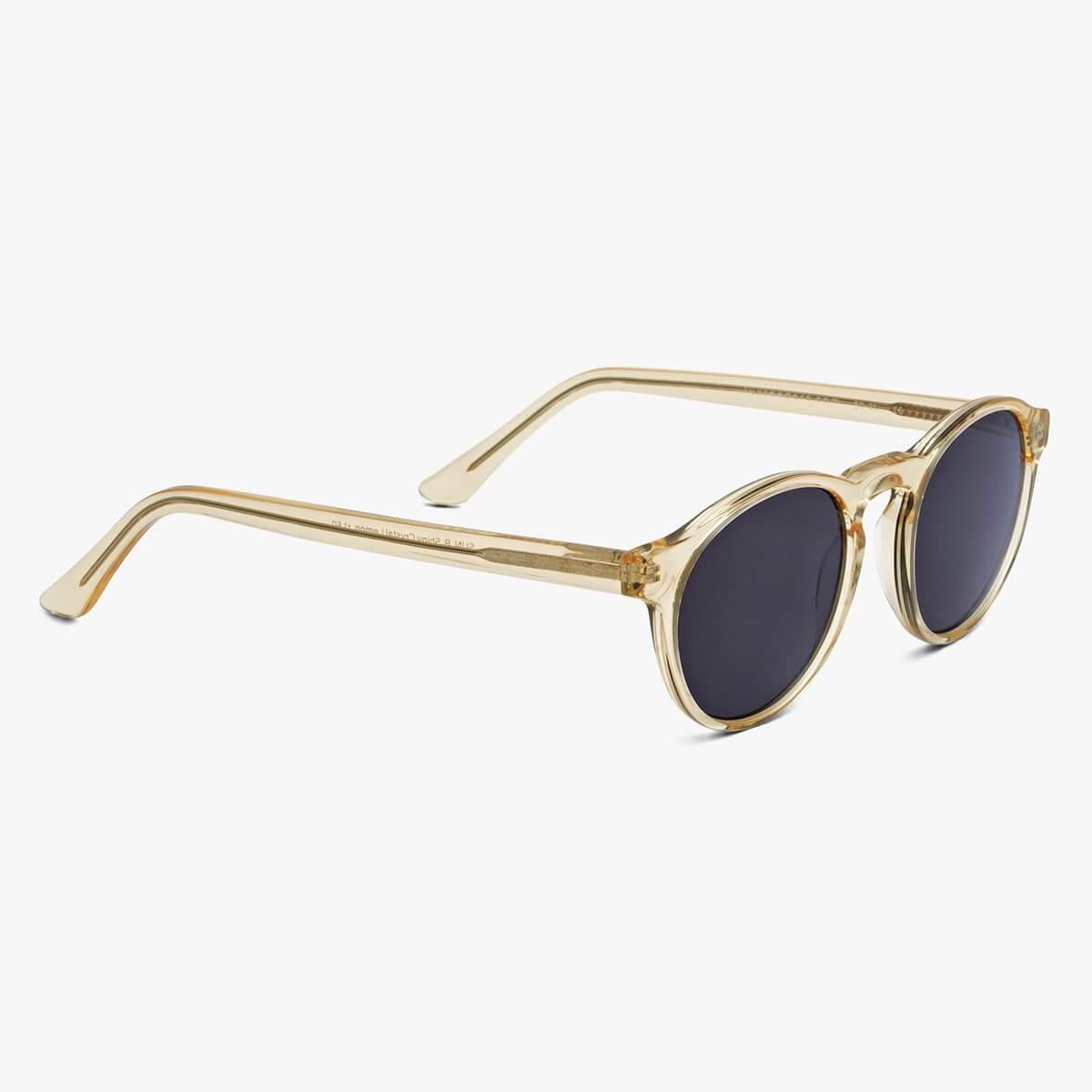 Round crystal lemon sunglasses with dark lenses and transparent gold temples